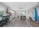 Bright dining room with natural light, light gray walls, hardwood-style floors, and an adjacent bar area at 653 Goodwin Ave, New Smyrna Beach, FL 32169
