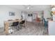 Dining room with hardwood-style floors, black dining set, view to the kitchen, and stylish nautical decor at 653 Goodwin Ave, New Smyrna Beach, FL 32169