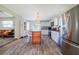 Bright kitchen features a center island with wood accents, white cabinets, stainless steel appliances, and an eat-in kitchen at 653 Goodwin Ave, New Smyrna Beach, FL 32169