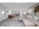 Open concept living room featuring hardwood style floors, a white front door, and views to the kitchen at 653 Goodwin Ave, New Smyrna Beach, FL 32169
