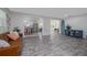 Open concept living room featuring hardwood style floors and views to the kitchen and dining room at 653 Goodwin Ave, New Smyrna Beach, FL 32169