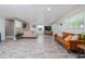Spacious living room showcasing hardwood style floors, a large sectional, and lots of natural light at 653 Goodwin Ave, New Smyrna Beach, FL 32169