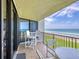 Balcony with seating and sliding glass doors with ocean views at 6727 Turtlemound Rd # 318, New Smyrna Beach, FL 32169