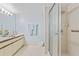 Clean and bright bathroom featuring a spacious vanity, ample lighting, and a glass-enclosed shower at 6727 Turtlemound Rd # 318, New Smyrna Beach, FL 32169