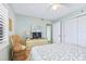 Well-lit bedroom with a ceiling fan, wardrobe and large windows, creating a comfortable and airy atmosphere at 6727 Turtlemound Rd # 318, New Smyrna Beach, FL 32169