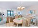 Dining room with seating for six and views through the sliding glass doors to the ocean at 6727 Turtlemound Rd # 318, New Smyrna Beach, FL 32169