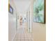 Bright hallway featuring tiled flooring and tasteful decor, creating a welcoming and well-maintained path through the home at 6727 Turtlemound Rd # 318, New Smyrna Beach, FL 32169