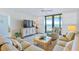 Inviting living room with comfortable seating and access to the balcony at 6727 Turtlemound Rd # 318, New Smyrna Beach, FL 32169