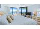 Bright main bedroom with ocean views from the balcony, featuring a comfortable bed and stylish furnishings at 6727 Turtlemound Rd # 318, New Smyrna Beach, FL 32169