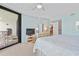 Light-filled main bedroom with balcony access, complemented by soft hues, and modern furnishings at 6727 Turtlemound Rd # 318, New Smyrna Beach, FL 32169