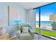 Relaxing sitting area with ocean views, comfortable armchair, and natural light, perfect for unwinding at 6727 Turtlemound Rd # 318, New Smyrna Beach, FL 32169