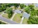 Aerial view of a home showcasing the fenced yard, mature trees, and neighborhood at 680 Buford Ave, Orange City, FL 32763