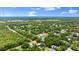 Aerial view of the property nestled in a community of trees at 680 Buford Ave, Orange City, FL 32763