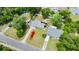 Aerial view of the property showcasing the layout of the home, driveway, and surrounding area at 680 Buford Ave, Orange City, FL 32763