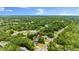 Aerial view of the property showcasing lush greenery, landscaping, and the surrounding neighborhood at 680 Buford Ave, Orange City, FL 32763