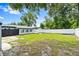 Spacious backyard showcasing a wooden deck, fire pit and patio, shed, and vinyl fence, providing a versatile outdoor space at 680 Buford Ave, Orange City, FL 32763