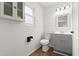 Cozy bathroom featuring wood floors, updated fixtures, and a cabinet above the toilet, maximizing storage at 680 Buford Ave, Orange City, FL 32763