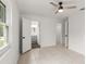 Bright bedroom with tile floors, two doorways, and a window offering natural light and a view at 680 Buford Ave, Orange City, FL 32763
