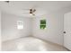 Bright bedroom with tile floors, ceiling fan, and windows offering natural light and a view at 680 Buford Ave, Orange City, FL 32763