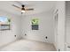 Bright bedroom with tile floors, ceiling fan, and windows offering natural light and ample closet space at 680 Buford Ave, Orange City, FL 32763