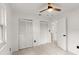 Bright bedroom with ceiling fan, tile floors, and double closets offers comfort and plenty of storage at 680 Buford Ave, Orange City, FL 32763