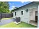 View of the exterior of a house with a fenced yard and door to an outdoor storage room at 680 Buford Ave, Orange City, FL 32763