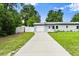 Single-story home featuring a concrete driveway, one-car garage, well-maintained lawn, and light blue exterior at 680 Buford Ave, Orange City, FL 32763