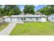 Charming single-story home featuring a well-manicured lawn, attached garage, and sidewalk leading to the front door at 680 Buford Ave, Orange City, FL 32763