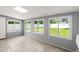 Bright sunroom features tile floors and multiple windows, creating a light-filled space with a view to the yard at 680 Buford Ave, Orange City, FL 32763