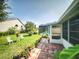 Spacious backyard with brick patio, lush lawn, and potential to relax and entertain in outdoor setting at 686 Middlebury Loop, New Smyrna Beach, FL 32168