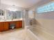 Bright bathroom featuring a double vanity, large soaking tub, and a glass-enclosed shower at 686 Middlebury Loop, New Smyrna Beach, FL 32168
