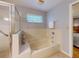 Bathroom featuring a soaking tub and a separate glass-enclosed shower at 686 Middlebury Loop, New Smyrna Beach, FL 32168