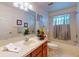 Well-lit bathroom features a vanity, mirror, and combination bathtub and shower, offering a functional and stylish space at 686 Middlebury Loop, New Smyrna Beach, FL 32168