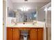 Bathroom featuring double sinks, a large mirror, a shower, and a tub at 686 Middlebury Loop, New Smyrna Beach, FL 32168
