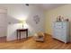 Bright bedroom with wood flooring, neutral walls, and a view of the door, creating a serene atmosphere at 686 Middlebury Loop, New Smyrna Beach, FL 32168