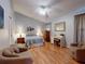 Serene bedroom with light blue walls, ceiling fan, wood floors, and comfortable furnishings at 686 Middlebury Loop, New Smyrna Beach, FL 32168