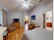 Spacious bedroom with two armchairs, wood flooring, and ensuite bathroom view at 686 Middlebury Loop, New Smyrna Beach, FL 32168