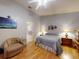 Comfortable bedroom with a decorative wall hanging, chair, and ensuite bathroom view at 686 Middlebury Loop, New Smyrna Beach, FL 32168