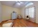 Comfortable bedroom with light walls, wood floors, and a window for natural light at 686 Middlebury Loop, New Smyrna Beach, FL 32168