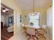 Charming breakfast nook with natural light, decorative wall plates, and adjacent living area at 686 Middlebury Loop, New Smyrna Beach, FL 32168
