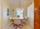 Cozy breakfast nook featuring an octagonal table, four chairs, and decorative stained glass lighting at 686 Middlebury Loop, New Smyrna Beach, FL 32168