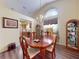 Cozy dining room featuring a chandelier, hardwood floors, and arched window at 686 Middlebury Loop, New Smyrna Beach, FL 32168