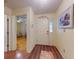 Inviting foyer with decorative front door, painting, and wood flooring, offering a warm welcome into the home at 686 Middlebury Loop, New Smyrna Beach, FL 32168