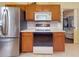 Modern kitchen with stainless steel refrigerator and range, complemented by hardwood cabinets at 686 Middlebury Loop, New Smyrna Beach, FL 32168