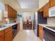 Well-lit kitchen featuring tile floors, stainless steel appliances, and view of dining room at 686 Middlebury Loop, New Smyrna Beach, FL 32168