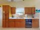 Well-lit kitchen featuring tile floors, and hardwood cabinets at 686 Middlebury Loop, New Smyrna Beach, FL 32168