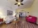 Inviting living room with ceiling fan, hardwood floors, and comfortable seating arrangement at 686 Middlebury Loop, New Smyrna Beach, FL 32168