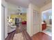 Spacious living room features vaulted ceiling, fan, wood flooring, and views of the home's bathroom and living areas at 686 Middlebury Loop, New Smyrna Beach, FL 32168