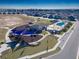 Aerial view showcases community park, playground, and a sparkling pool amidst beautiful homes at 7223 Sw 61St Pl, Ocala, FL 34474