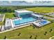 Stunning aerial view of a new aquatic center with large pool, modern architecture, and recreational waterpark area at 7223 Sw 61St Pl, Ocala, FL 34474